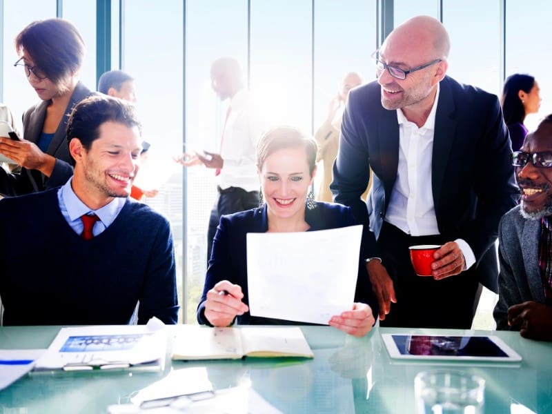 A group of people sitting around a table.